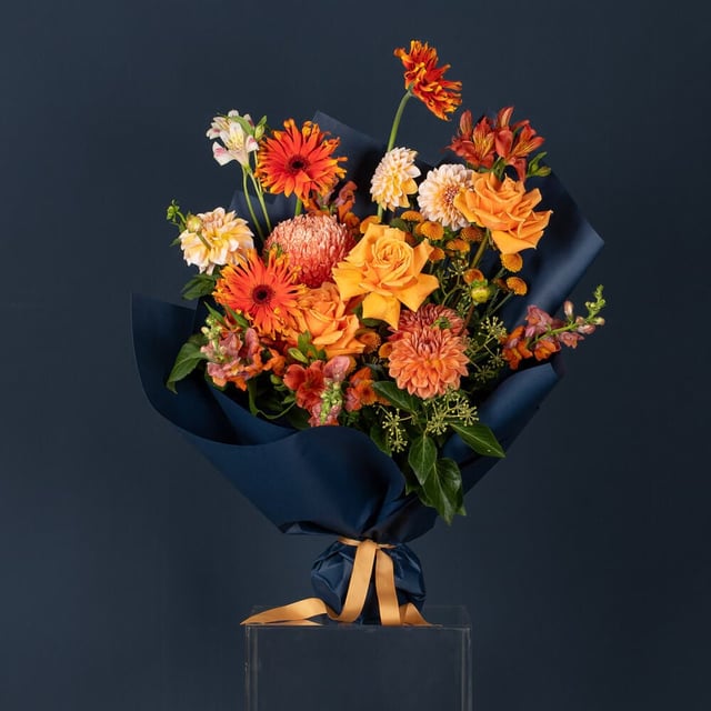 Tangelo Samba arrangement featuring bold orange, red, and pink blooms in a vibrant, tropical-inspired design by If The Florist in Maroubra, Sydney.